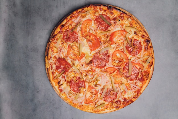 Pizza pepperoni, mozzarella, oregano on a black background.