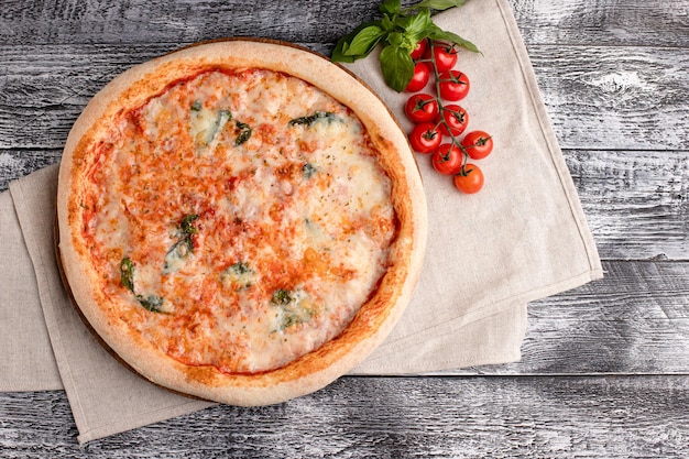 Pizza pizza on a wooden white background top view