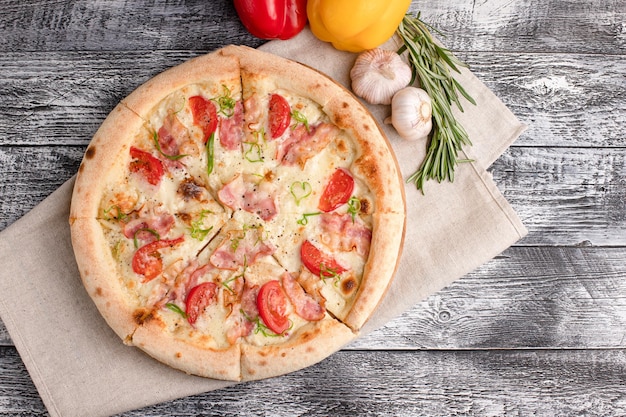 Pizza pizza on a wooden white background top view