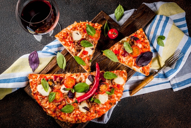 Pizza and red wine on dark background 