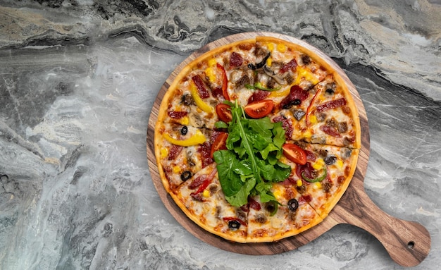 Pizza served on wooden plate