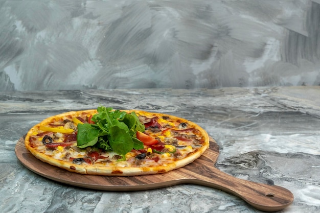 Pizza served on wooden plate