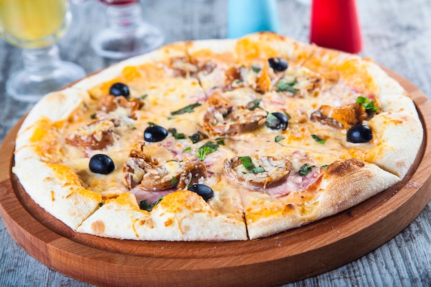 pizza stuffed with tomatoes and cheese on a wooden table