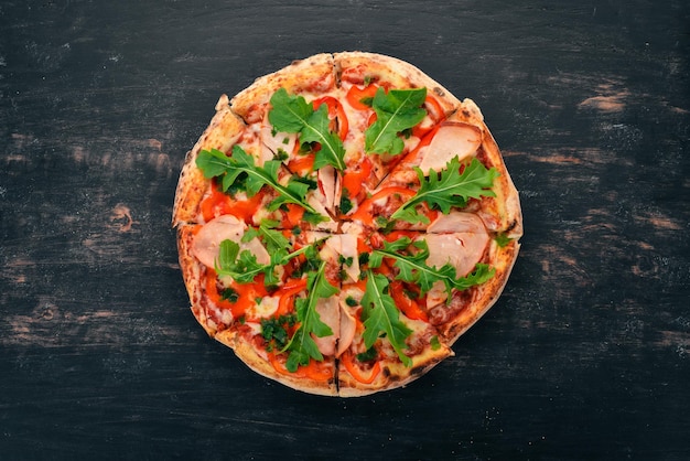 Pizza with bacon paprika and arugula Italian cuisine On a wooden background Free space for text Top view