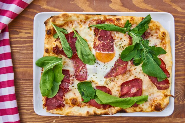 Pizza with Bacon on Wooden Table