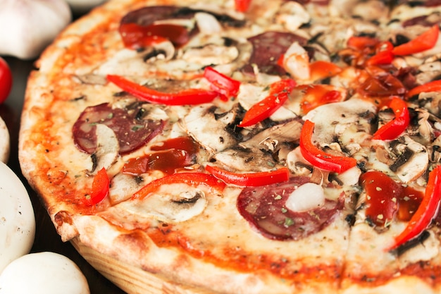 Pizza with bell pepper, onion and sausage close up