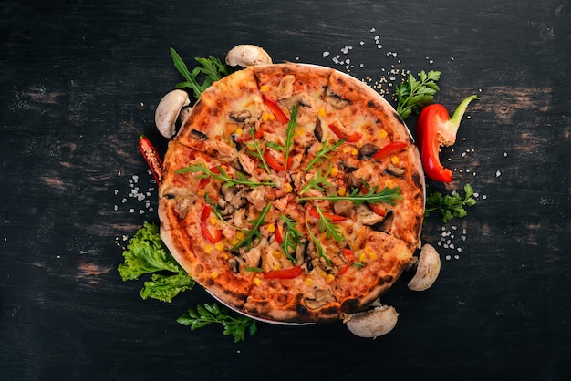 Pizza with chicken and mushrooms Top view On a wooden background Copy space