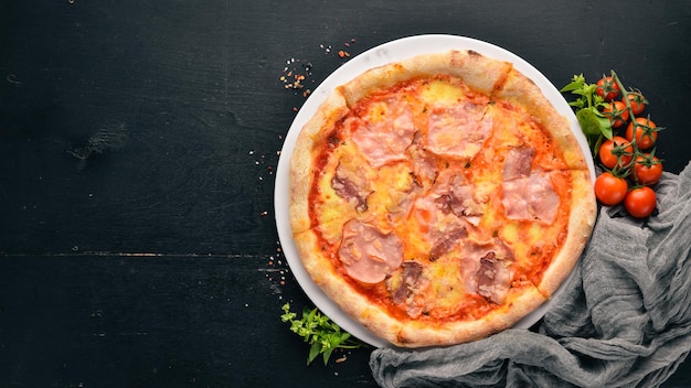 Pizza with ham and Parmesan cheese On a wooden background Top view Free space for your text