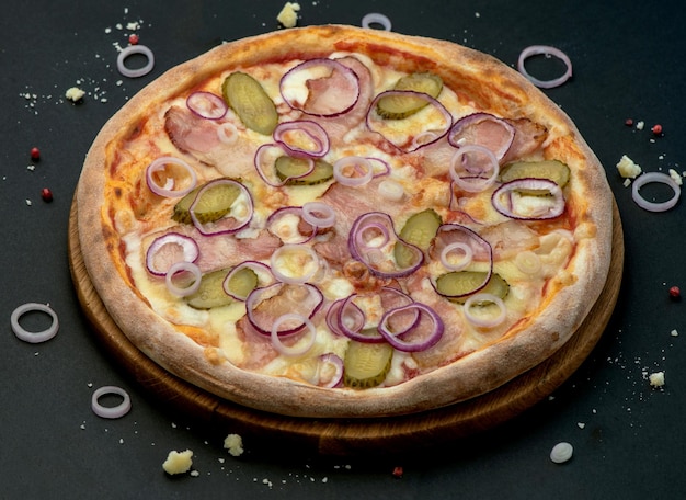 Pizza with Mozzarella cheese ham tomato sauce pepper pickled cucumbers and onion Italian pizza