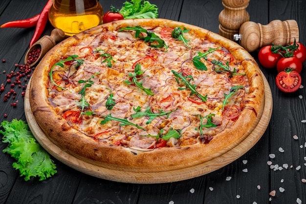 Pizza with Mozzarella cheese salami chicken meat beef ham Tomato sauce pepper spices Italian pizza on dark background