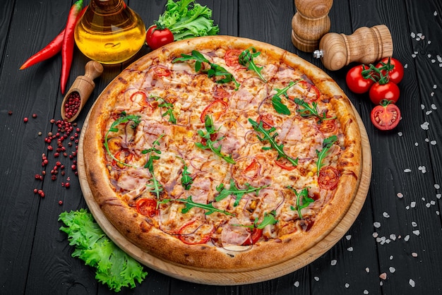 Pizza with Mozzarella cheese salami chicken meat beef ham Tomato sauce pepper spices Italian pizza on dark background