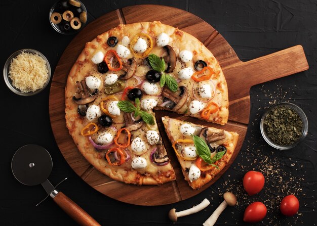 Pizza with mozzarella ,olives and mushroom. Italian cuisine. Ingredients for making pizza