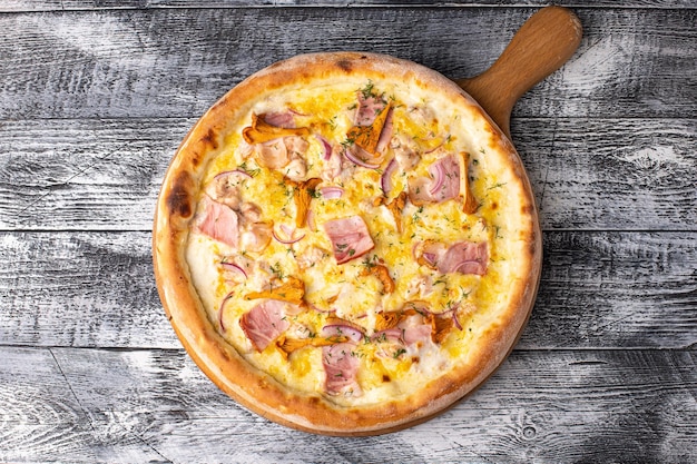 Pizza with mushrooms pizza with chanterelles on a white wooden background