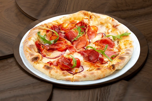 Pizza with Parma ham and cherry tomatoes On a wooden background