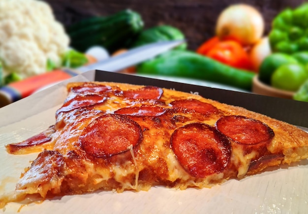 Pizza with pepperoni mozzarella and tomatoes