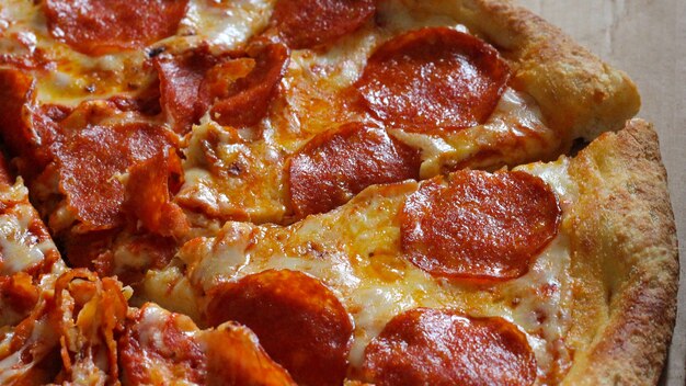 Pizza with pepperoni, tomato sauce and cheese. Italian traditional food. Popular street food