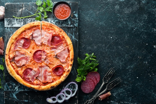 Pizza with salami and bacon on the old table Italian snacks Top view Free space for your text