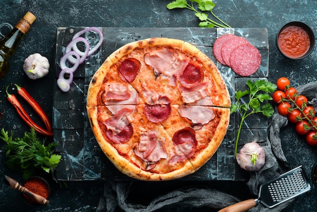 Pizza with salami and bacon on the old table Italian snacks Top view Free space for your text