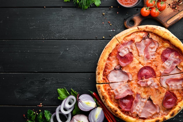 Pizza with salami and bacon on the old table Italian snacks Top view Free space for your text