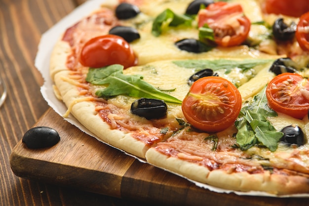 Pizza with tomatoes cheese and arugula