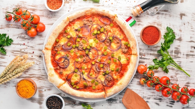 Pizza with tuna and onion Italian traditional dish On the old background Top view Free space for your text