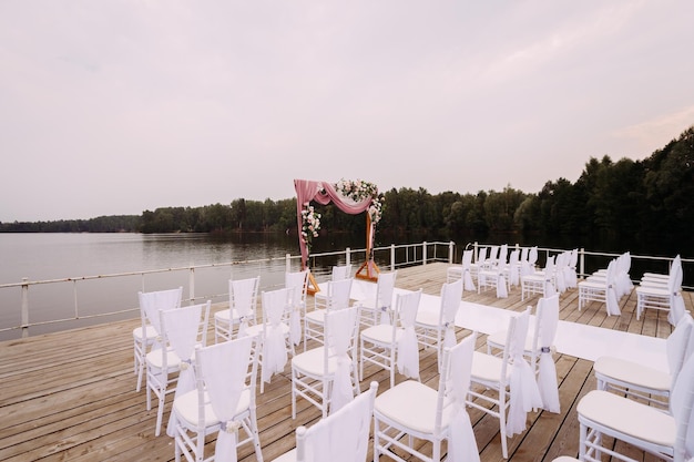 A place decorated for a wedding ceremony on the shore of a pond 4385