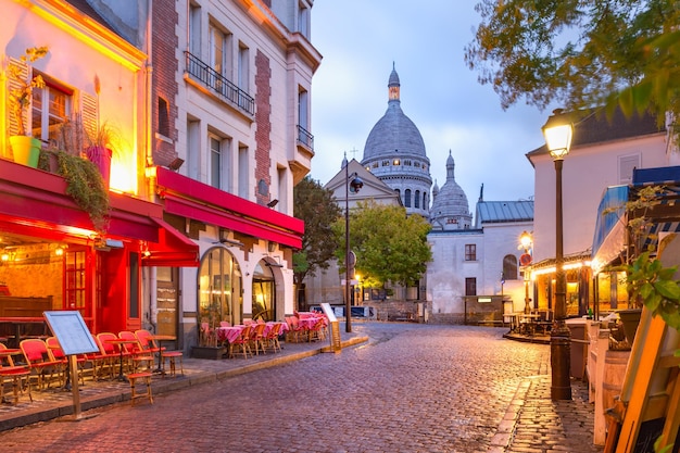 The place du tertre with tables of cafe and the sacrecoeur in the morning quarter montmartre in pari