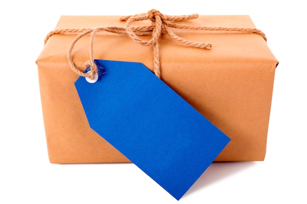 Photo plain brown paper package or parcel, blue gift tag