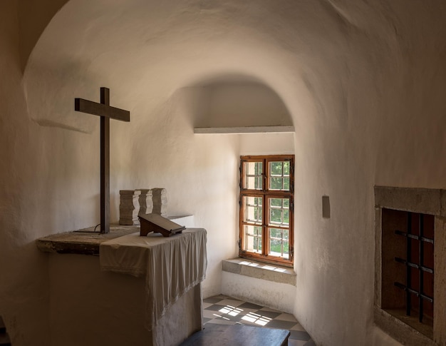 Plain church altar in Predjama castle built into a cave in Slovenia