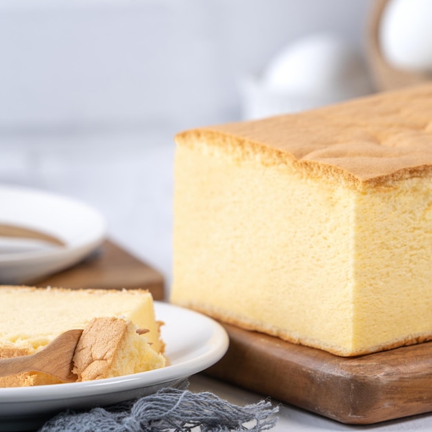 Plain classic Taiwanese traditional sponge cake Taiwanese castella kasutera on a wooden tray background table with ingredients close up