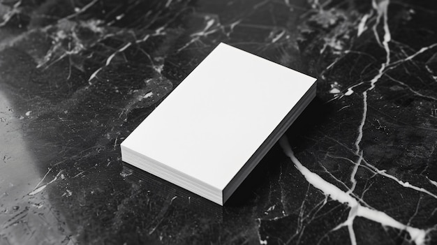 A plain white business card placed on a black marble surface symbolizing formality and simplicity