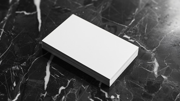 A plain white business card placed on a black marble surface symbolizing formality and simplicity