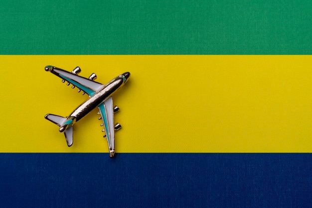 Plane over the flag of Gabon the concept of travel