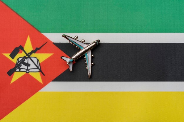 Plane over the flag of Mozambique the concept of journey