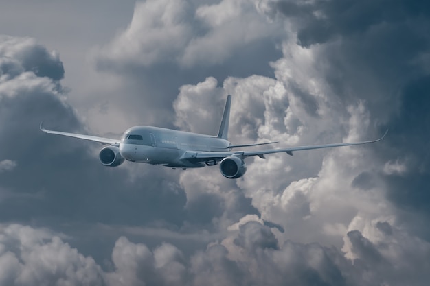 Plane flies in the sky among storm clouds