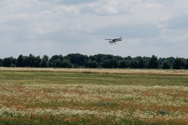 Plane flying in the sky over the airfield sport leisure activity