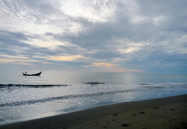 a plane is flying over the ocean and the sky is blue