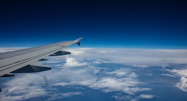 Plane wing on blue sky background