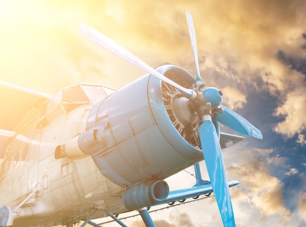 Plane with propeller on sunset sky background