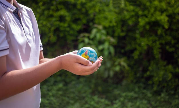 Planet earth in the boy's hands saves and protects the world Environmental concept on Earth Day