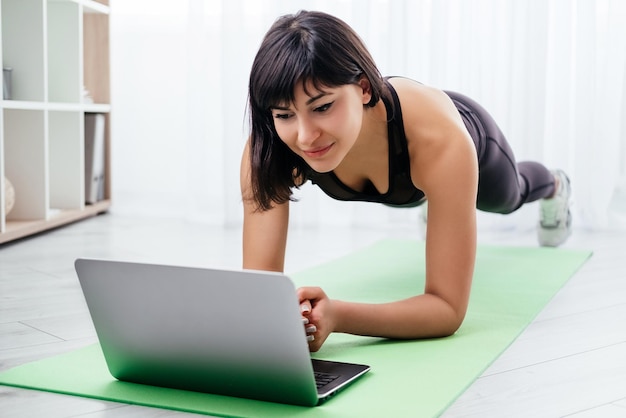 Plank workout sportive woman online fitness