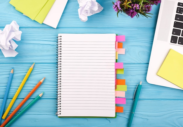 Planner on the wooden working table with computer blank white paper on working desk