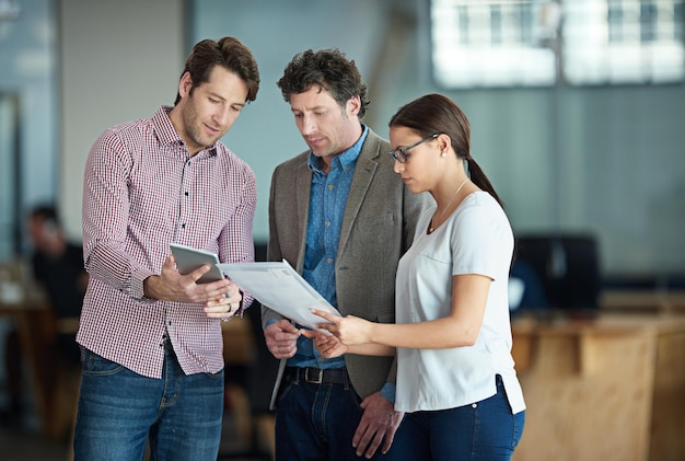 Planning thinking and brainstorming professional business team collaborating and sharing a plan or idea on a digital tablet in an office Group of entrepreneurs checking financial risk and reports