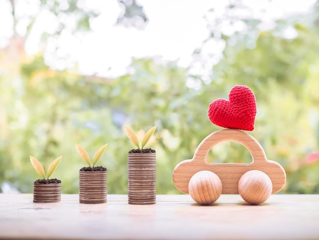 Plants growing up on stack of coins with toy car for transport and manage success business concept