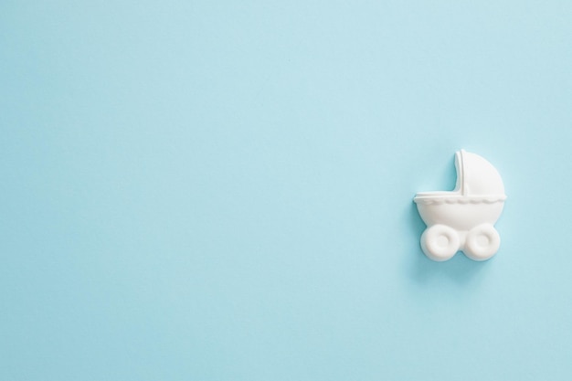 A plaster figure of a baby carriage on a colored background