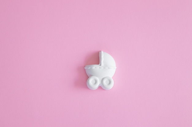 A plaster figure of a baby carriage on a colored background