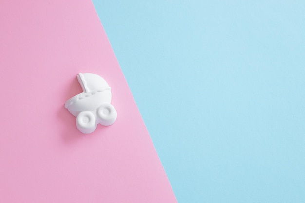 A plaster figure of a baby carriage on a colored background