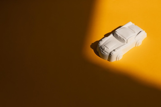 Plaster figure of a car on a colored background