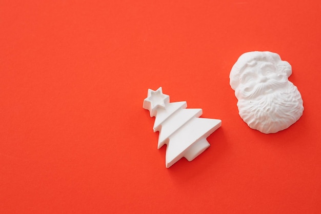 Plaster figure of Christmas tree on a colored background