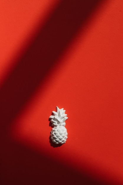 A plaster figure of a pineapple on a colored background